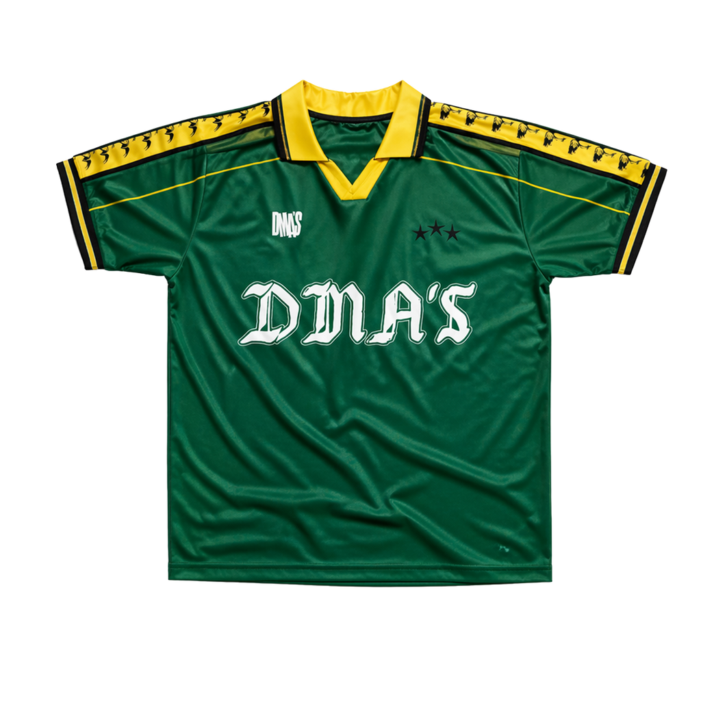 Green sports jersey with yellow accents and 'DMA'S' branding.