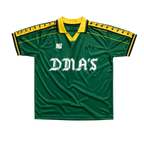 Green sports jersey with yellow accents and 'DMA'S' branding.