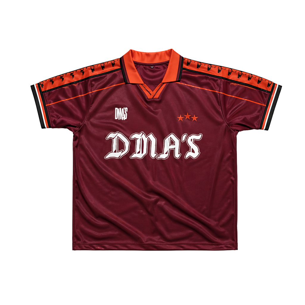 Maroon sports jersey with orange accents and 'DMA'S' branding.