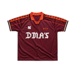Maroon sports jersey with orange accents and 'DMA'S' branding.