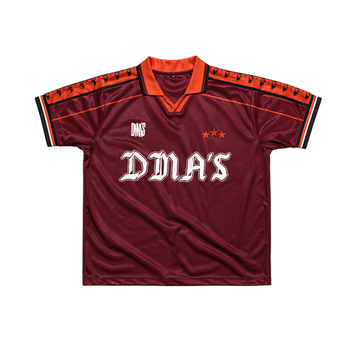 Maroon sports jersey with orange accents and 'DMA'S' branding.